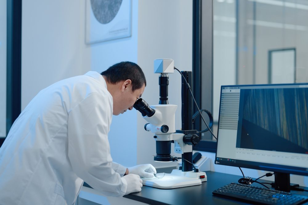 R&D engineer performing microscopic inspection