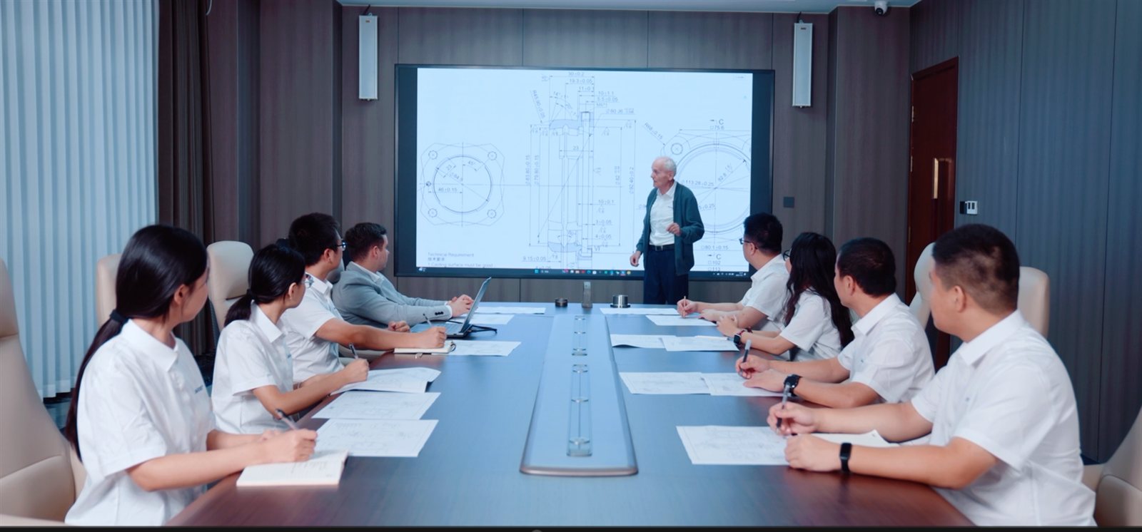 Zhongda engineers reviewing bearing drawings in a technical meeting